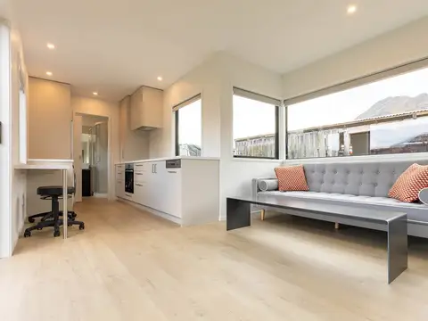 Timber-floored room with mountain view